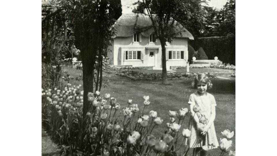 young girl standing in front of Wendy house