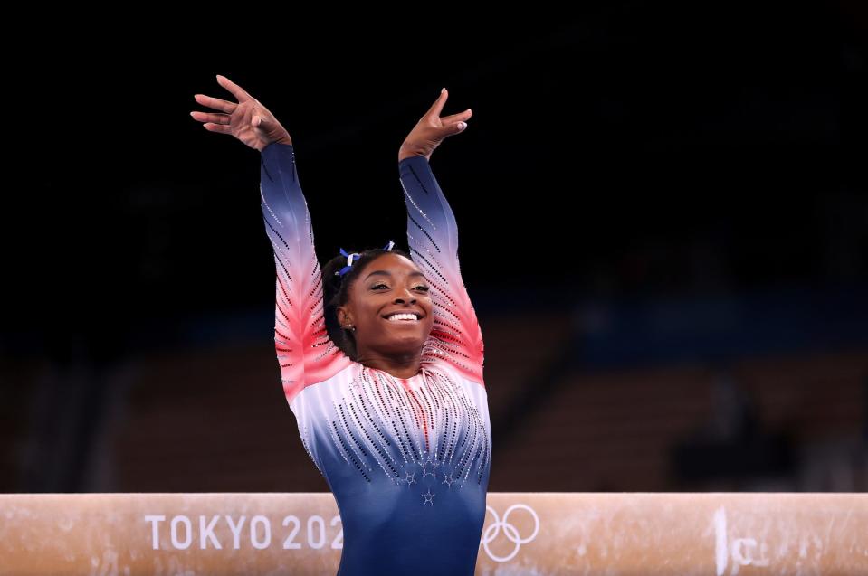 Simone Biles smiles after her balance beam routine at the Tokyo Olympics.