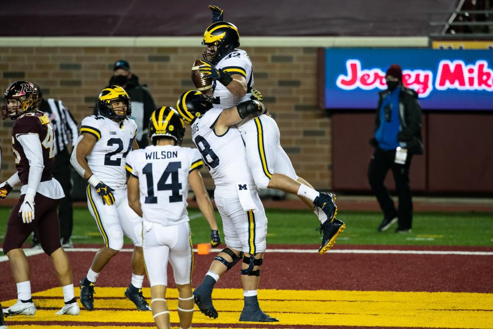 Michigan fullback Ben Mason celebrates with Andrew Vastardis after scoring a touchdown against the Minnesota Golden Gophers in the first quarter of the game at TCF Bank Stadium on Oct. 24, 2020 in Minneapolis, Minnesota.