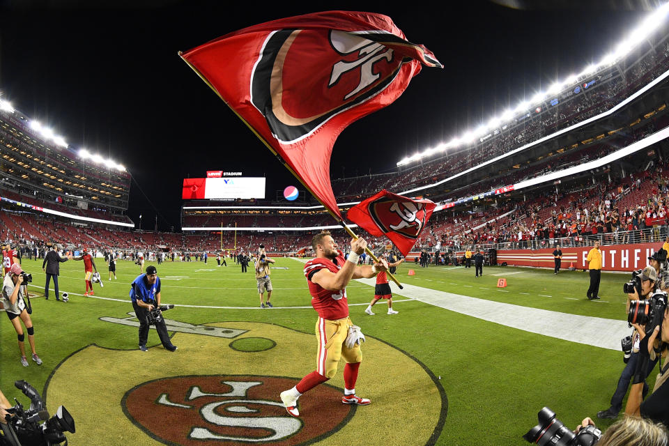 San Francisco 49ers defensive end Nick Bosa (97) waves a 49ers flag after beating the Browns on Monday night. (Getty Images)