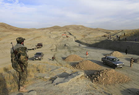 An Afghan security personnel keeps watch at a road construction site, which is being built by a Chinese company, in Khogyani district of Nangarhar province November 19, 2015. REUTERS/Parwiz