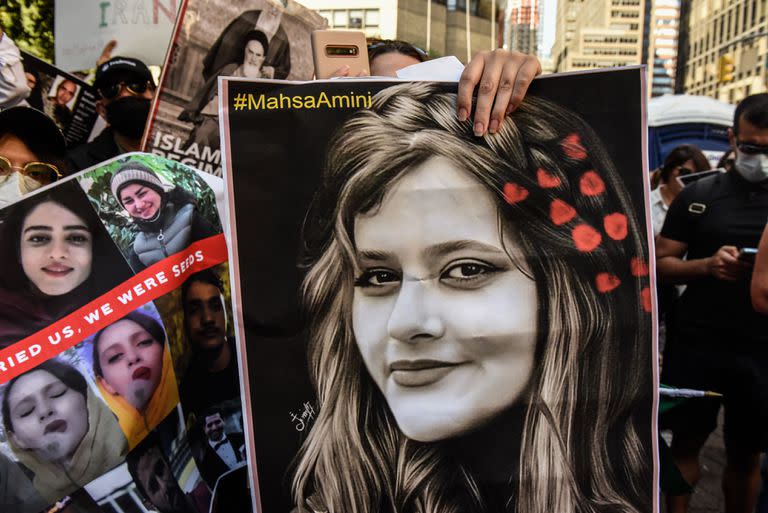 NEW YORK, NY - SEPTEMBER 21: People participate in a protest against Iranian President Ebrahim Raisi outside of the United Nations on September 21, 2022 in New York City. Protests have broke out over the death of 22-year-old Iranian woman Mahsa Amini, who died in police custody for allegedly violating the country's hijab rules. Amini's death has sparked protests across Iran and other countries.   Stephanie Keith/Getty Images/AFP