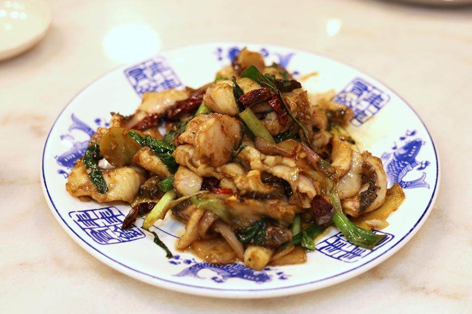 The 'kung pao' fish slices is coated in a subtle brown sauce and stir fried with spring onions and dried red chillies.