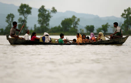 FILE PHOTO: Rohingya refugees are seen on a boat as they are crossing border through the Naf river in Teknaf, Bangladesh, September 7, 2017. REUTERS/Mohammad Ponir Hossain/File Photo