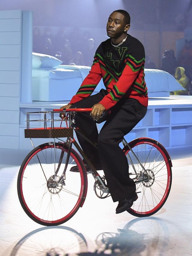 Tyler The Creator riding through the Louis Vuitton fashion show on