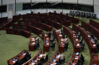 Empty seats of pro-democracy legislators, top, are seen as Hong Kong Chief Executive Carrie Lam delivers her policies at chamber of the Legislative Council in Hong Kong, Wednesday, Nov. 25, 2020. Lam said Wednesday that the city's new national security law has been “remarkably effective in restoring stability” after months of political unrest, and that bringing normalcy back to the political system is an urgent priority. (AP Photo/Kin Cheung)