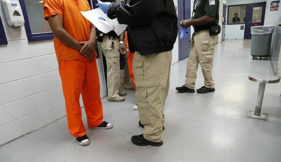 A detainee is processed by a guard in the medical unit at Krome detention center in 2015.