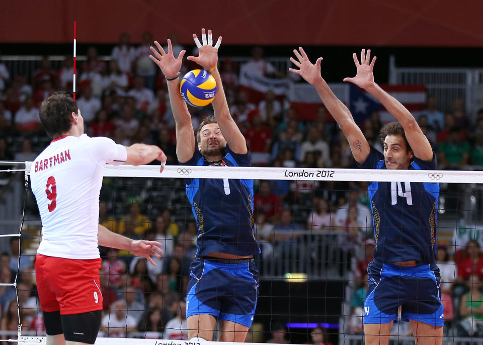 LONDON, ENGLAND - JULY 29: Michal Lasko #7 and Alessandro Fei #14 of Italy try to stop a shot by Zbigniew Bartman #9 of Poland during Men's Volleyball on Day 2 of the London 2012 Olympic Games at Earls Court on July 29, 2012 in London, England. (Photo by Elsa/Getty Images)
