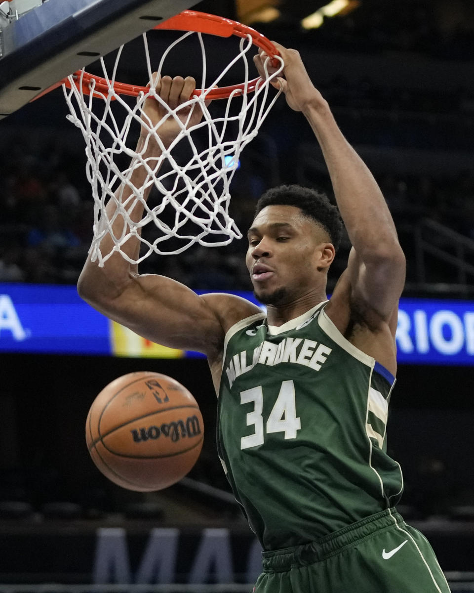 Milwaukee Bucks' Giannis Antetokounmpo (34) makes an uncontested dunk against the Orlando Magic during the second half of an NBA basketball game, Monday, Dec. 5, 2022, in Orlando, Fla. (AP Photo/John Raoux)