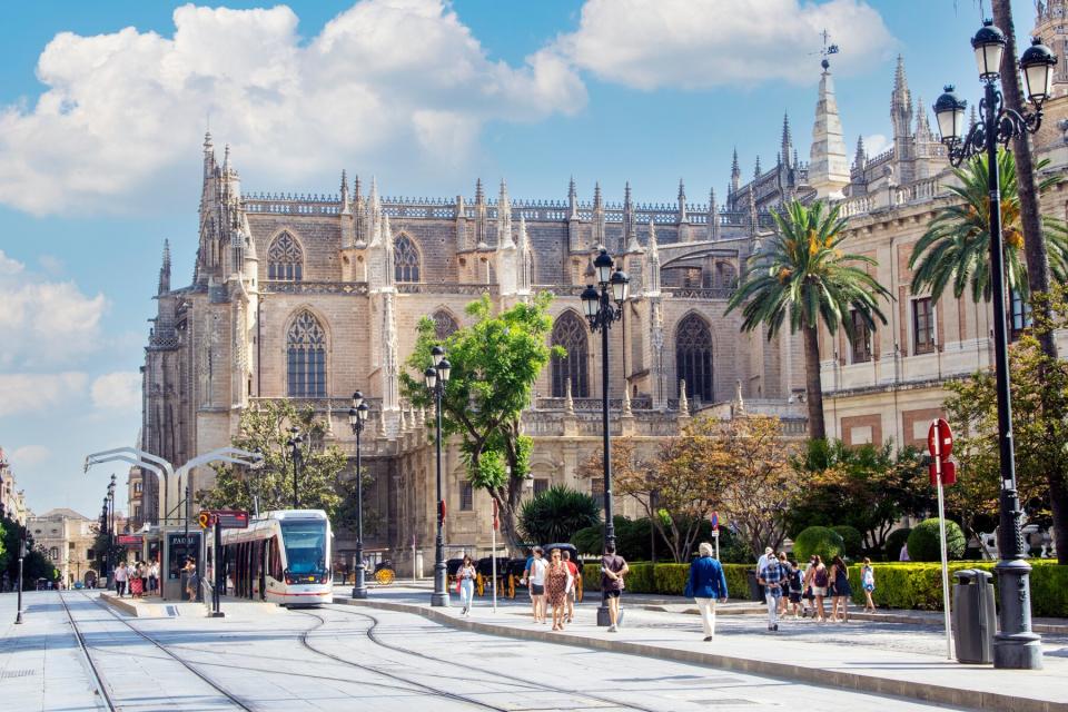 Tourist walking in the street of Seville in the south of Spain in a sunny day.