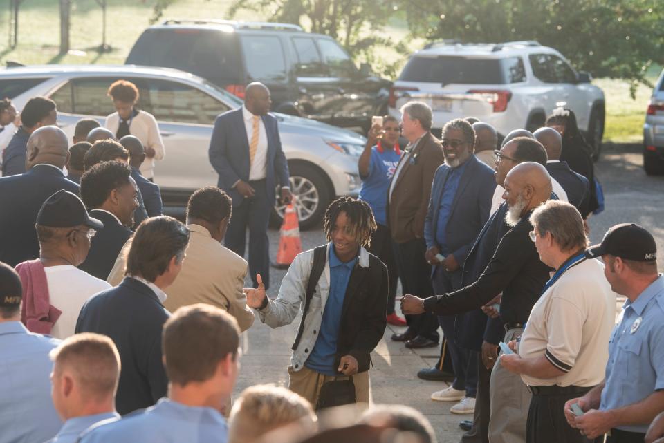 Members of the community welcome students at Lanier High School in Montgomery, Ala., on Wednesday, Sept. 14, 2022.