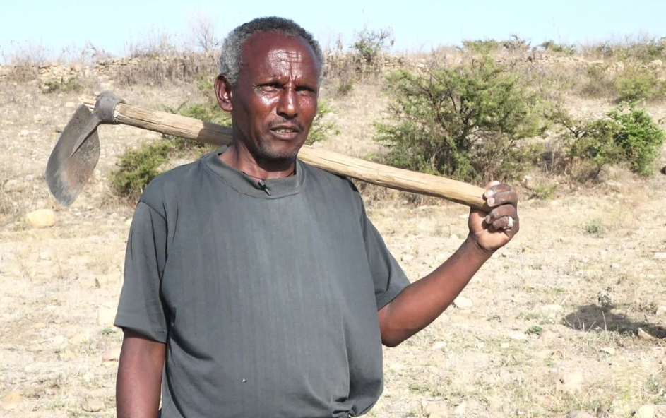 Man holding an agricultural tool