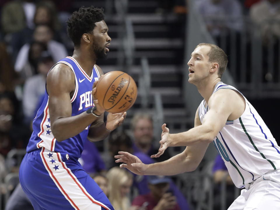 Philadelphia 76ers' Joel Embiid, left, drives against Charlotte Hornets's Cody Zeller during the first half of an NBA basketball game in Charlotte, N.C., Saturday, Nov. 17, 2018. (AP Photo/Chuck Burton)