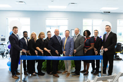 Hospital leadership posing before cutting the ribbon