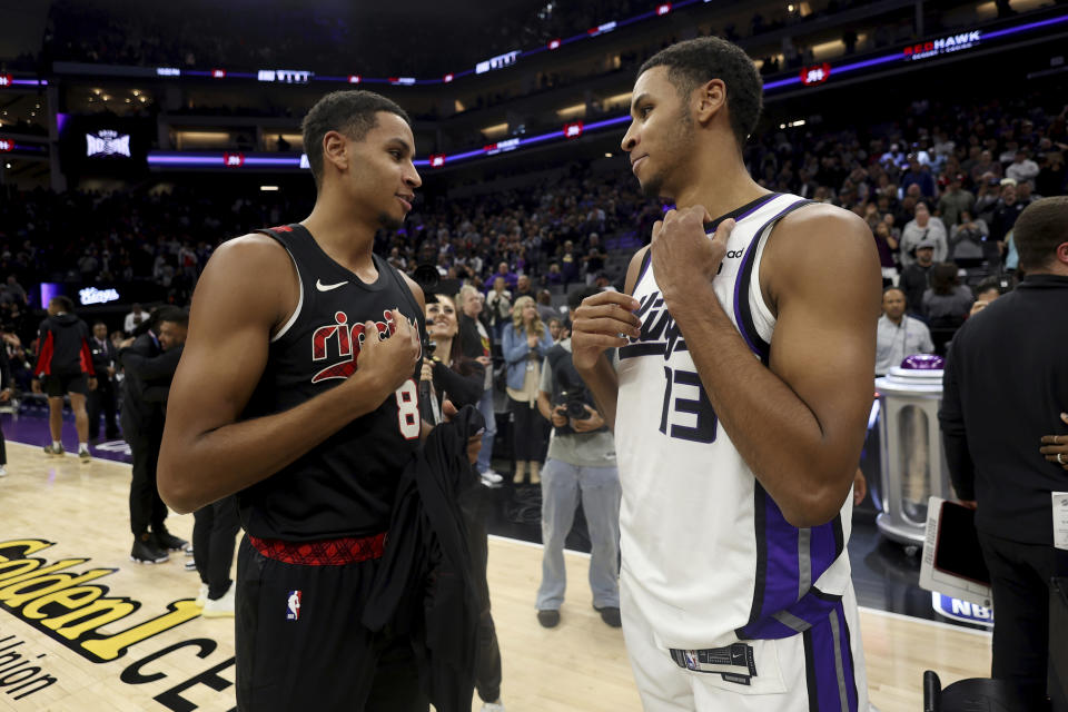 Sacramento Kings forward Keegan Murray, right, speaks with Portland Trail Blazers forward Kris Murray after an NBA basketball game in Sacramento, Calif, Wednesday, Nov. 8, 2023. (AP Photo/Jed Jacobsohn)