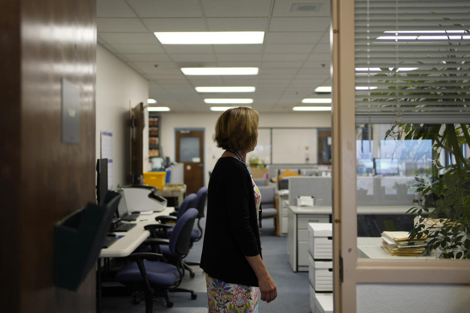 Nye County Clerk Sam Merlino stands outside of her office, Monday, July 18, 2022, in Tonopah, Nev. Merlino is stepping down from the position, leaving the administration of elections in a county the size of New Hampshire to a new clerk. (AP Photo/John Locher)