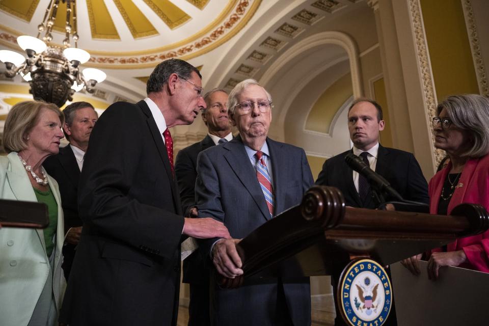Sen. John Barrasso helps Senate Minority Leader Mitch McConnell after he froze at the microphone on July 26, 2023. <a href="https://www.gettyimages.com/detail/news-photo/sen-john-barrasso-reaches-out-to-help-senate-minority-news-photo/1556768368?adppopup=true" rel="nofollow noopener" target="_blank" data-ylk="slk:Drew Angerer/Getty Images;elm:context_link;itc:0;sec:content-canvas" class="link ">Drew Angerer/Getty Images</a>