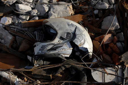 A motorbike helmet lies among rubble in Balaroa neighbourhood hit by an earthquake and ground liquefaction in Palu, Central Sulawesi, Indonesia, October 7, 2018. REUTERS/Jorge Silva