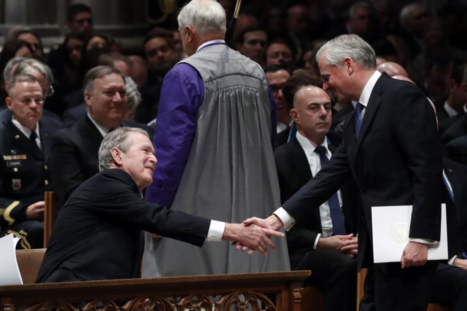 26) Jon Meacham shakes hands with George W. Bush.