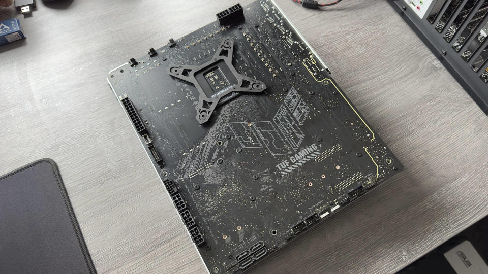 Asus TUF Gaming Z790-BTF motherboard on a grey desk