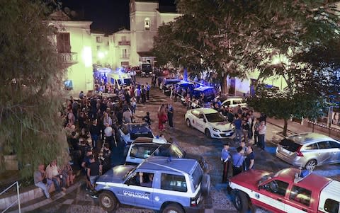 Rescuers and citizens wait in the central square of Civita, a village in the Italian Calabria southern region  - Credit: AFP