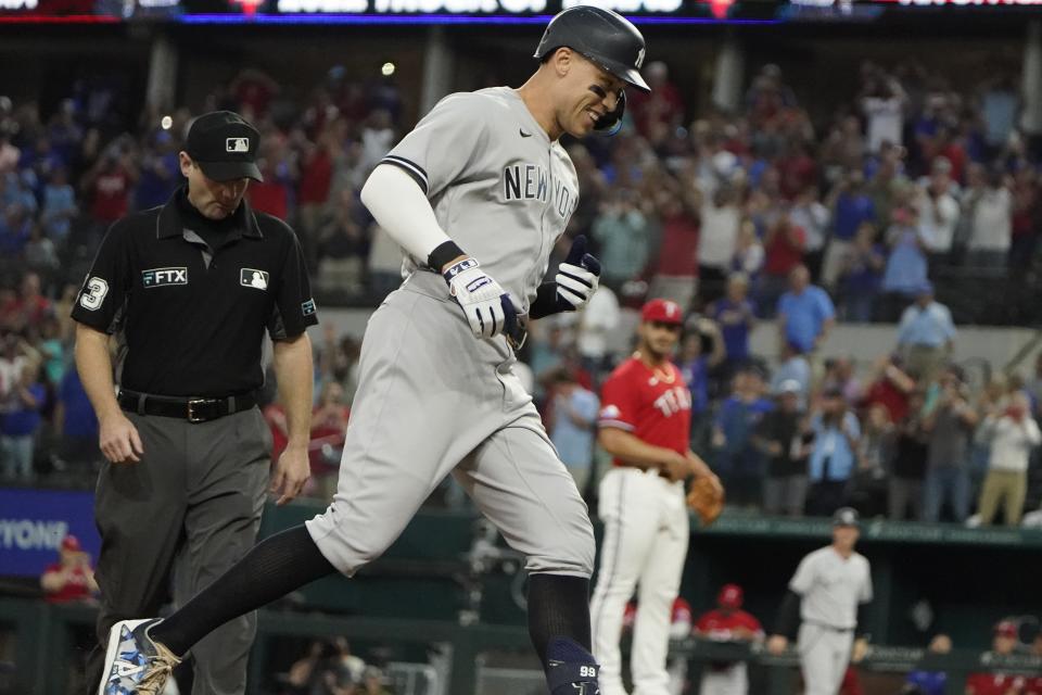 FILE - New York Yankees' Aaron Judge runs out his solo home run, his 62nd of the season, as Texas Rangers starting pitcher Jesus Tinoco looks on in the background during the first inning in the second baseball game in Arlington, Texas, Oct. 4, 2022 (AP Photo/LM Otero, File)