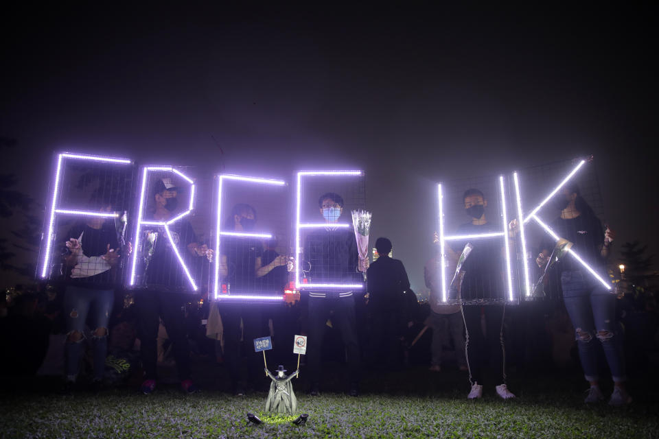 People attend a vigil for student Chow Tsz-Lok in Hong Kong, Saturday, Nov. 9, 2019. Chow Tsz-Lok, the Hong Kong university student who fell off a parking garage after police fired tear gas during clashes with anti-government protesters died Friday in a rare fatality in five months of unrest, fueling more outrage against authorities in the semi-autonomous Chinese territory. (AP Photo/Kin Cheung)