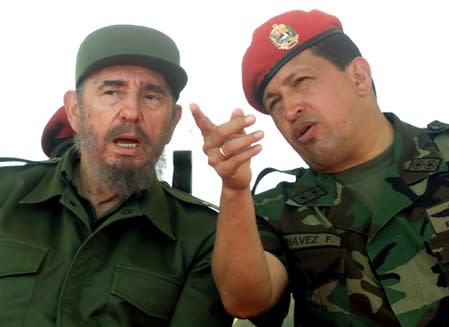 FILE PHOTO: Venezuelan President Hugo Chavez talks with Cuban President Fidel Castro at the port of Pampatar on Margarita Island