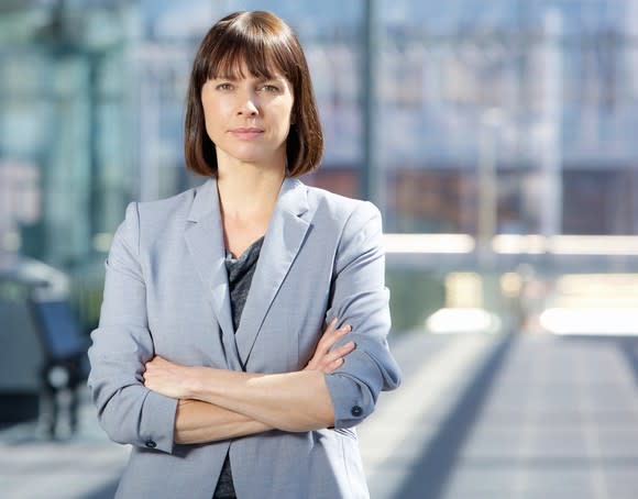 Woman in business suit with arms crossed