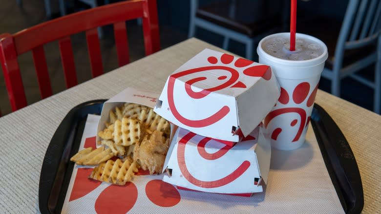 Chick-fil-A menu boxes and fries stacked on tray