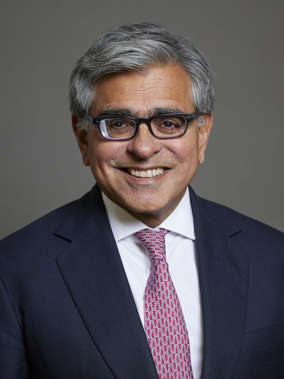 a man wearing glasses and a suit