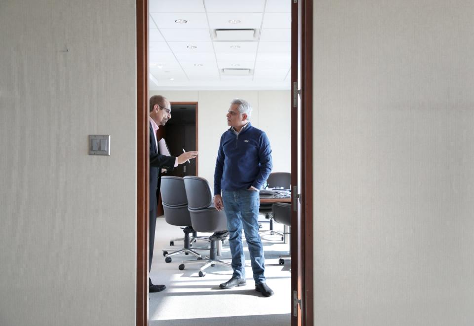 Kumar Galhotra, then-president of Ford North America, right, talks with Said Deep, head of North America communications, in Galhotra's office at Ford World Headquarters in Dearborn in December 2018. Galhotra is now president of Ford Blue, leading the company's business that focuses on vehicles with internal combustion engines.