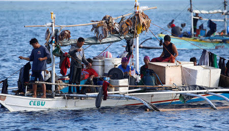 Filipino fishermen rest inside a cramped fishing boat at the disputed Scarborough Shoal April 6, 2017. Picture taken April 6, 2017. REUTERS/Erik De Castro