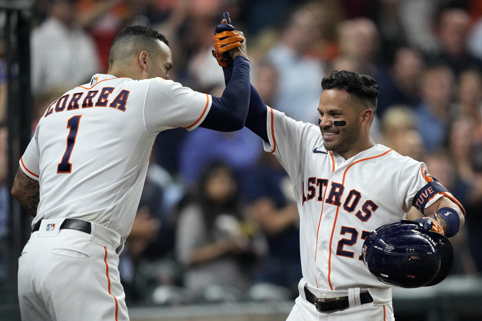 Houston Astros' Jose Altuve (27) celebrates with Carlos Correa (1) after hitting a home run against the Chicago White Sox during the sixth inning of a baseball game Thursday, June 17, 2021, in Houston. (AP Photo/David J. Phillip)