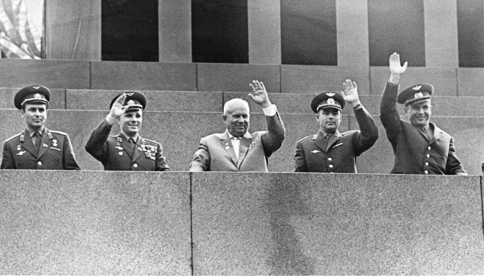 FILE - In this Aug. 18, 1962 file photo, Soviet Premier Nikita Khrushchev, center, is flanked by four Soviet cosmonauts as they wave from Lenin's tomb in Moscow's Red Square during a welcome ceremony for cosmonauts Andrian Nikolayev and Pavel Popovich who made a dual orbital space flight. From left are Gherman Titov, Yuri Gagarin, Khrushchev, Nikolayev and Popovich. The successful one-orbit flight on April 12, 1961 made the 27-year-old Gagarin a national hero and cemented Soviet supremacy in space until the United States put a man on the moon more than eight years later. (AP Photo/File)