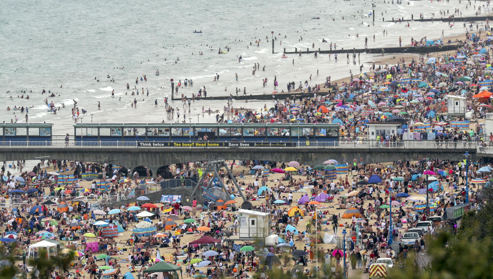 People enjoy the warm weather on Bournemouth beach. Met Office said Friday is the third hottest UK day on record as temperatures reached 37.8C at Heathrow Airport.