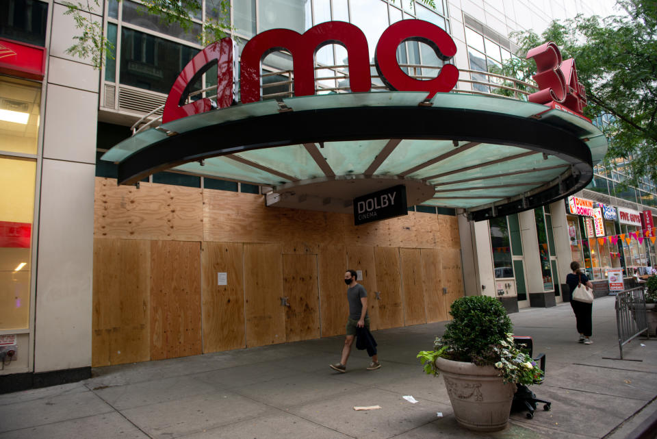 NEW YORK, NEW YORK - SEPTEMBER 24: A man wearing a mask walks past a boarded up an AMC movie theater at 34th Street as the city continues Phase 4 of re-opening following restrictions imposed to slow the spread of coronavirus on September 24, 2020 in New York City. 