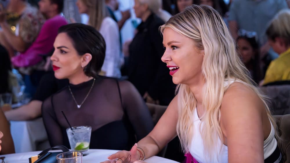  Katie Maloney and Ariana Madix dining at a table in Vanderpump Rules season 11. 