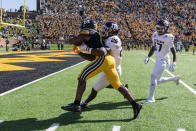 Missouri running back Tyler Badie, left, scores a touchdown past Texas A&M's Demani Richardson, center, Jaylon Jones, right, during the second quarter of an NCAA college football game against Texas A&M Saturday, Oct. 16, 2021, in Columbia, Mo. (AP Photo/L.G. Patterson)