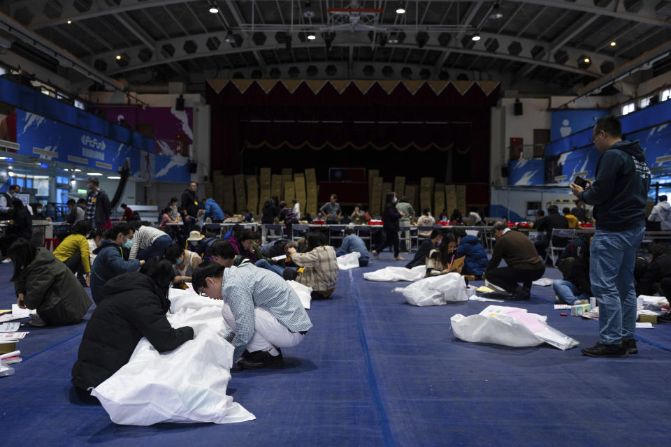 Staff prepare materials for polling booth in New Taipei, Taiwan on Friday, Jan. 12, 2024 ahead of the presidential election on Saturday. (AP Photo/Louise Delmotte)