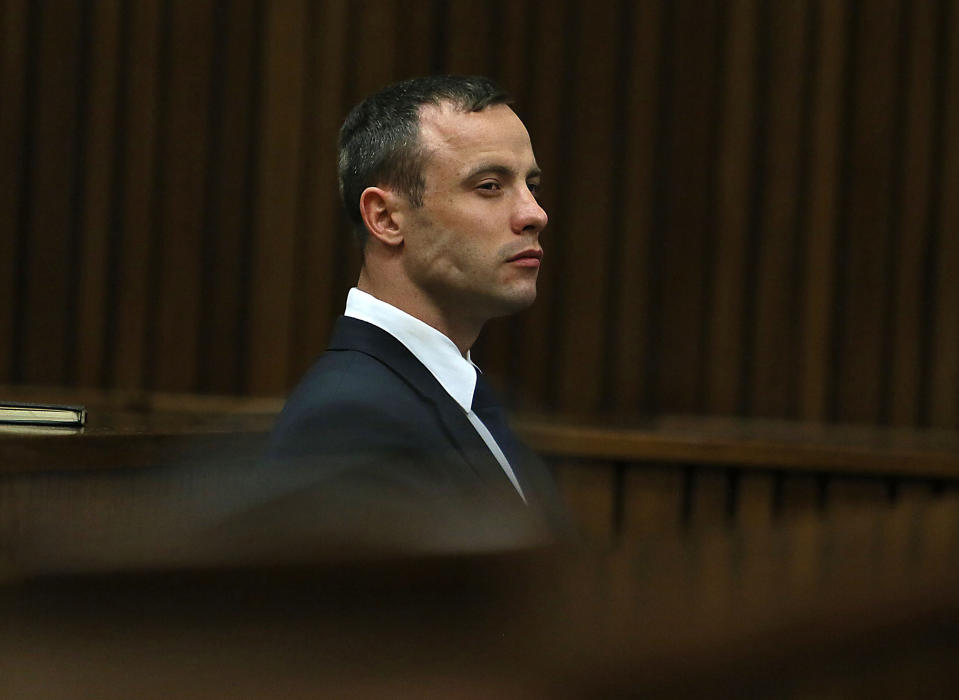 Oscar Pistorius listens to evidence being given in court in Pretoria, South Africa, Tuesday, April 15, 2014 after questioning by state prosecutor Gerrie Nel, had earlier finished. Pistorius is charged with the murder of his girlfriend Reeva Steenkamp, on Valentines Day in 2013. (AP Photo/Alon Skuy, Pool)