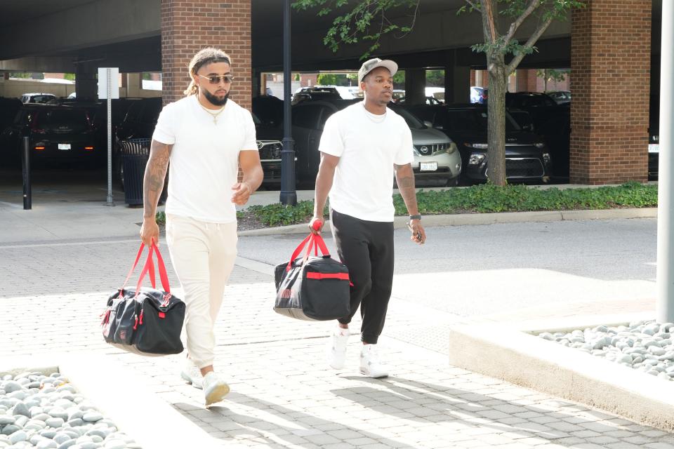 Gee Scott Jr. (left) and Tanner McCalister check into the team hotel on Aug. 8.