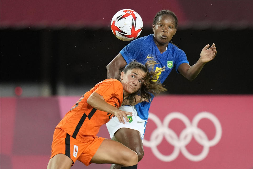 Netherlands' Danielle van de Donk, left, and Brazil's Formiga battle for the ball during a women's soccer match at the 2020 Summer Olympics, Saturday, July 24, 2021, in Miyagi, Japan. (AP Photo/Andre Penner)