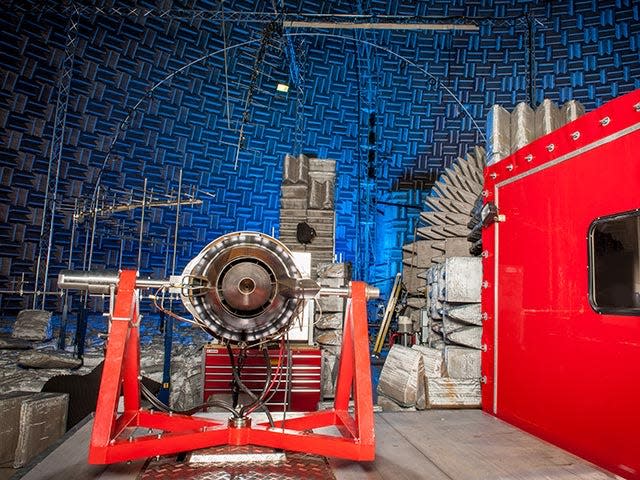 A red truck mounted turbofan engine inside of NASA's Aero-Acoustic Propulsion Laboratory.