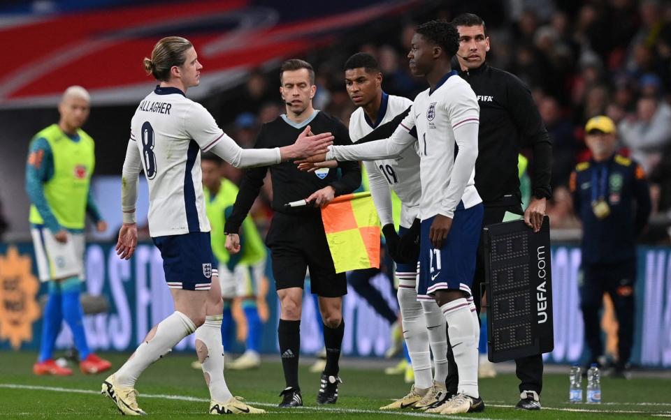 Kobbie Mainoo (right) comes on for his England debut