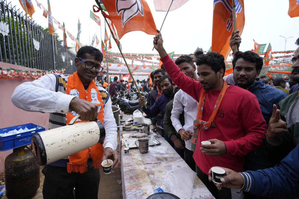 A man distributes free tea as supporters of India's ruling Bharatiya Janata Party, or BJP, celebrate early leads for the party in Rajasthan state elections in Jaipur, India, Sunday, Dec.3, 2023. Vote counting began Sunday in four Indian states in a test of strength for India's opposition pitted against the ruling party of Prime Minister Narendra Modi ahead of next year's crucial national vote. (AP Photo/Deepak Sharma)