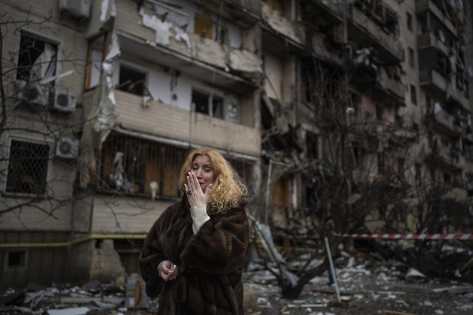 Natali Sevriukova cries in front of her apartment building destroyed in a rocket attack in Kyiv, Ukraine, Feb. 25, 2022. The image was part of a series of images by Associated Press photographers that was awarded the 2023 Pulitzer Prize for Breaking News Photography. (AP Photo/Emilio Morenatti)