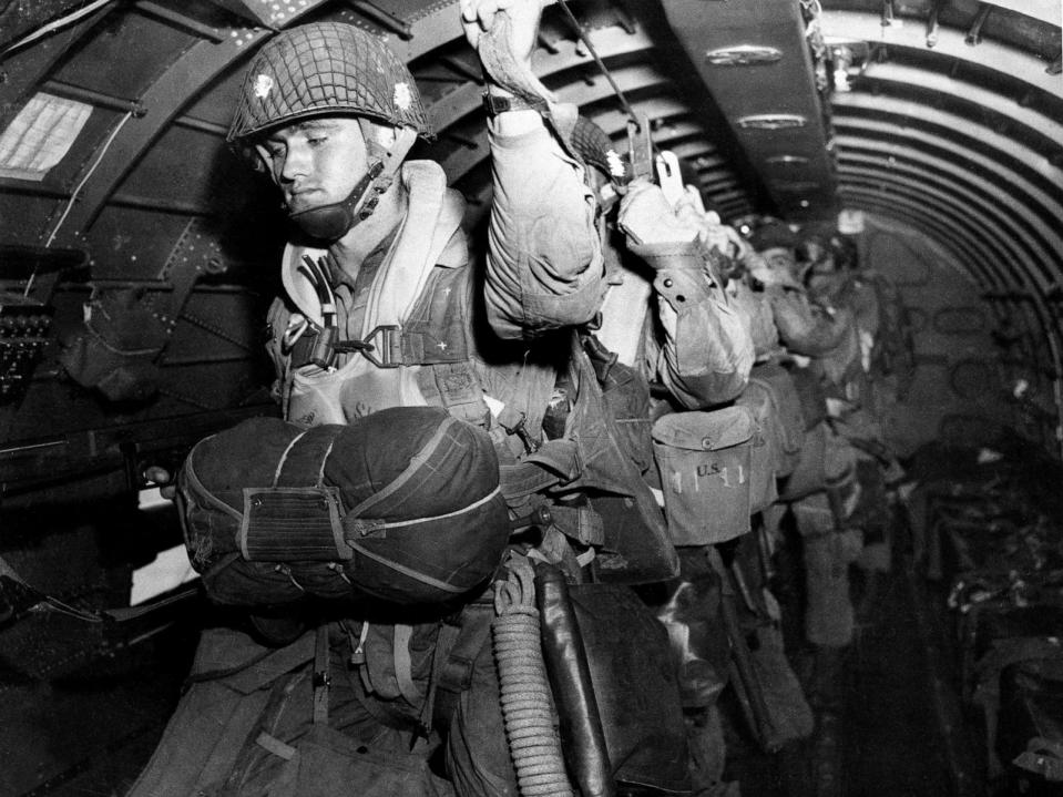 PHOTO: In this photo provided by the U.S. Army Signal Corps, U.S. paratroopers fix their static lines before a jump before dawn over Normandy on D-Day, June 6, 1944, in France. (U.S. Army Signal Corps/AP)