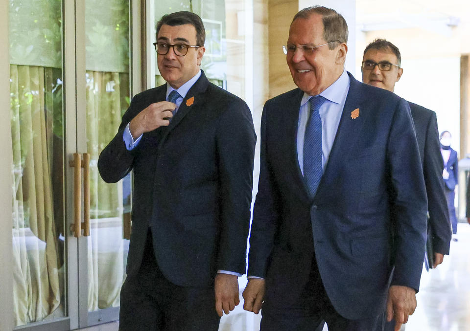 In this handout photo released by Russian Foreign Ministry Press Service, Russian Foreign Minister Sergey Lavrov, right, and Brazil Foreign Minister Carlos Alberto Franca walk during their bilateral meeting ahead of the G20 Foreign Ministers' Meeting in Nusa Dua, Bali, Indonesia, Bali, Indonesia, Friday, July 8, 2022. (Russian Foreign Ministry Press Service via AP)