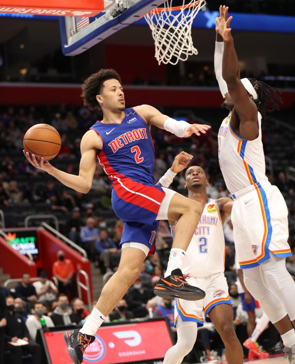 Pistons guard Cade Cunningham drives against Thunder guard Shai Gilgeous-Alexander during the second period of the Pistons' 114-103 loss on Monday, Dec. 6, 2021, at Little Caesars Arena.